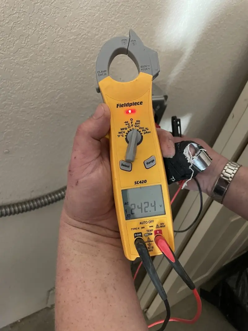 Voltage testing with clamp meter during Outlet Installation in Palmetto Estates